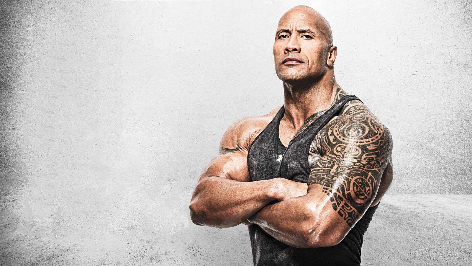 WWE legend and Hollywood star poses with arms crossed during promotional photo shoot