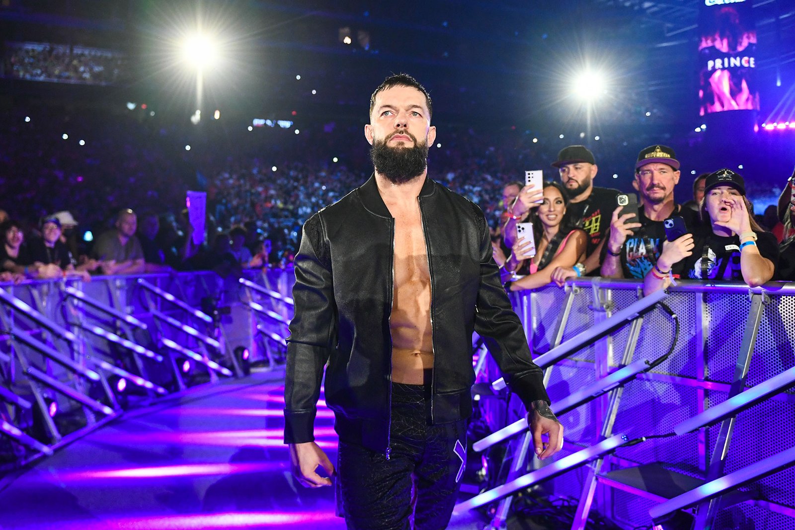 WWE superstar makes his entrance on RAW in Belfast as fans cheer behind the barricade