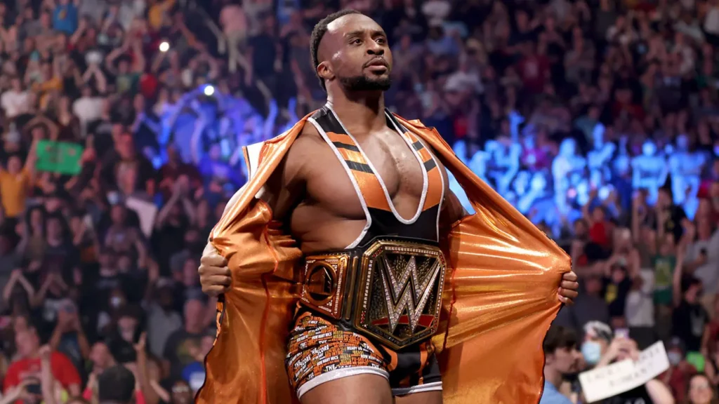 Professional wrestler Big E in the ring with an orange cape and the WWE Championship belt around his waist.