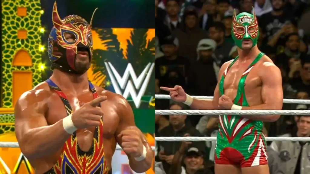 Two professional wrestlers, both wearing the Lucha Libre-inspired mask and gear of the character "El Grande Americano", stand in a WWE ring and point at each other. The wrestler on the left is the original, while the wrestler on the right is an imposter.