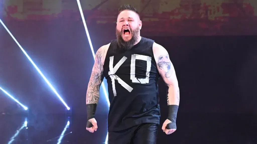 Kevin owens entrance moment on wwe stage - tjr wrestling Kevin owens makes his wwe entrance, shouting with intensity under bright arena lights.