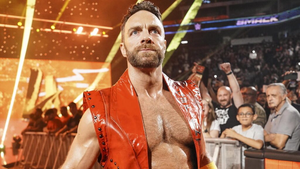 La knight walks toward the ring wearing a red vest as fans cheer behind the barricade during a live wwe smackdown event. - tjr wrestling