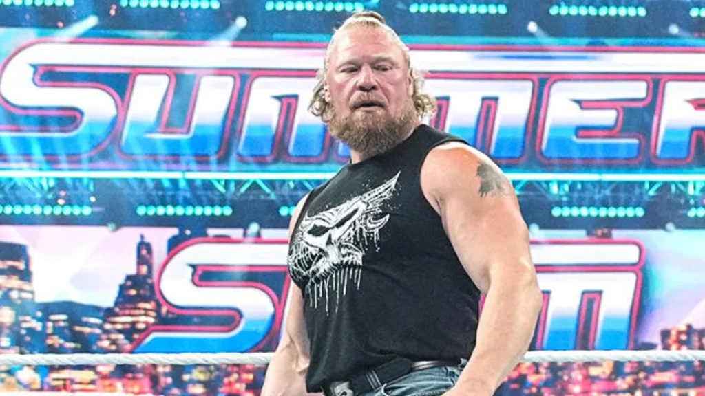 Professional wrestler brock lesnar stands in a wwe ring with a serious expression, looking toward the side. He has long blonde hair tied in a small bun, a full blonde and grey beard, and is wearing a black sleeveless t-shirt with a stylized white skull graphic. Behind him, a massive digital screen displays the vibrant blue and pink "summerslam" logo over a city skyline at night. - tjr wrestling