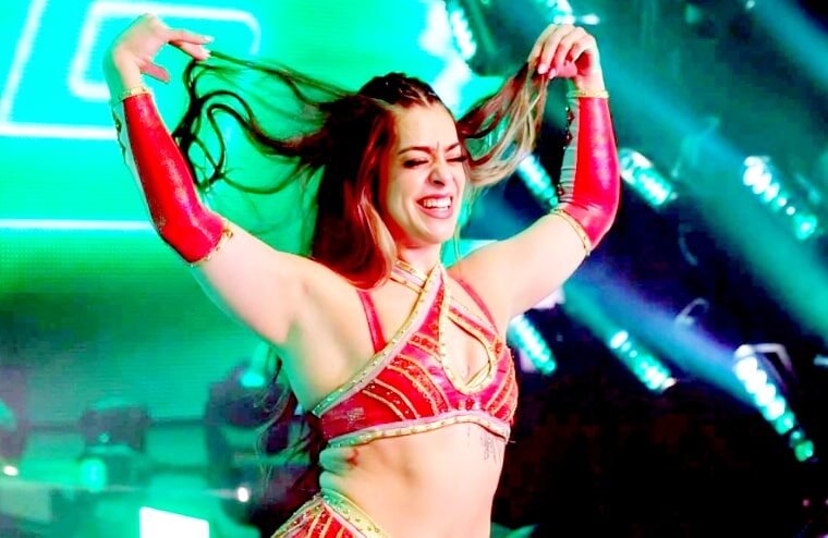 Sirena linton performing in wwe ring wearing red gear under stage lights - tjr wrestling
