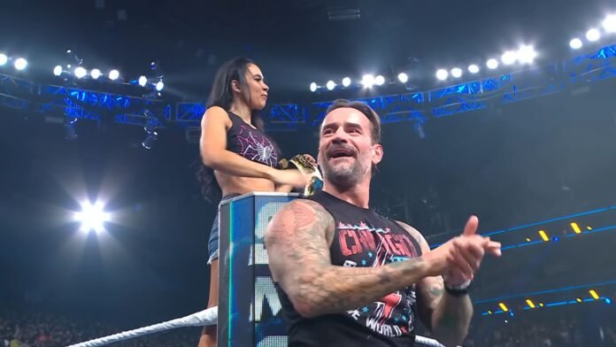 AJ Lee and CM Punk react to the crowd during AJ Lee's return appearance on WWE SmackDown.