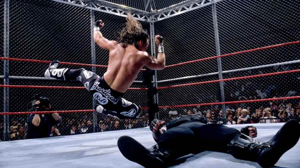 Shawn michaels vs the undertaker in hell in a cell - tjr wrestling Shawn michaels delivers his signature elbow drop to the undertaker during their historic hell in a cell match at badd blood 1997.