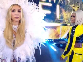 Massive Jade Cargill Pinfall Victory Shocks Charlotte Flair Charlotte Flair wearing a elaborate white feathered robe stands in the foreground while Jade Cargill in a yellow and black jumpsuit looks on from behind.