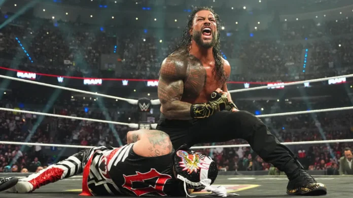 WWE Superstar Roman Reigns roaring in victory over a fallen Penta inside a packed wrestling arena ring.
